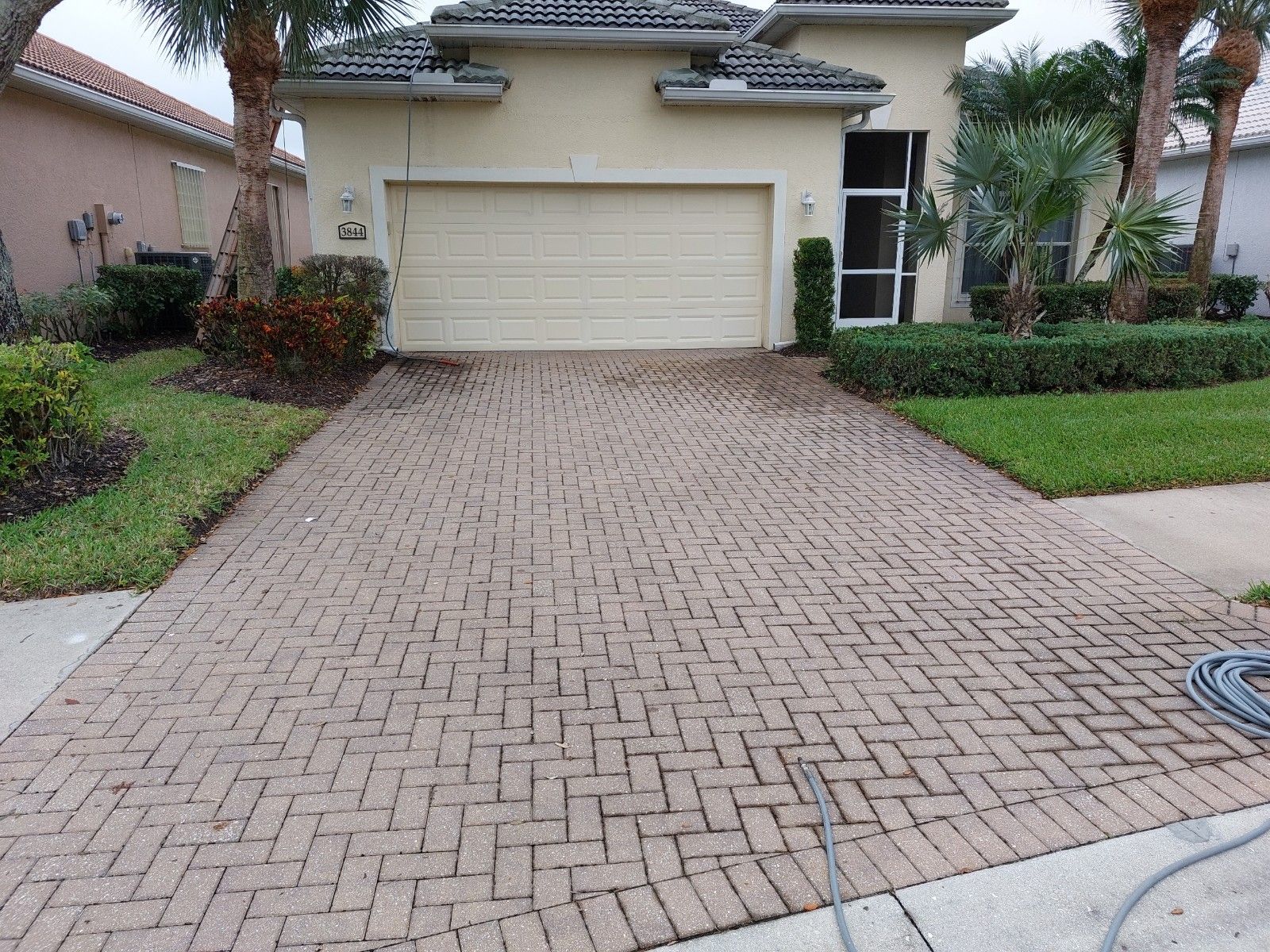 Paver driveway before pressure washing — Naples FL