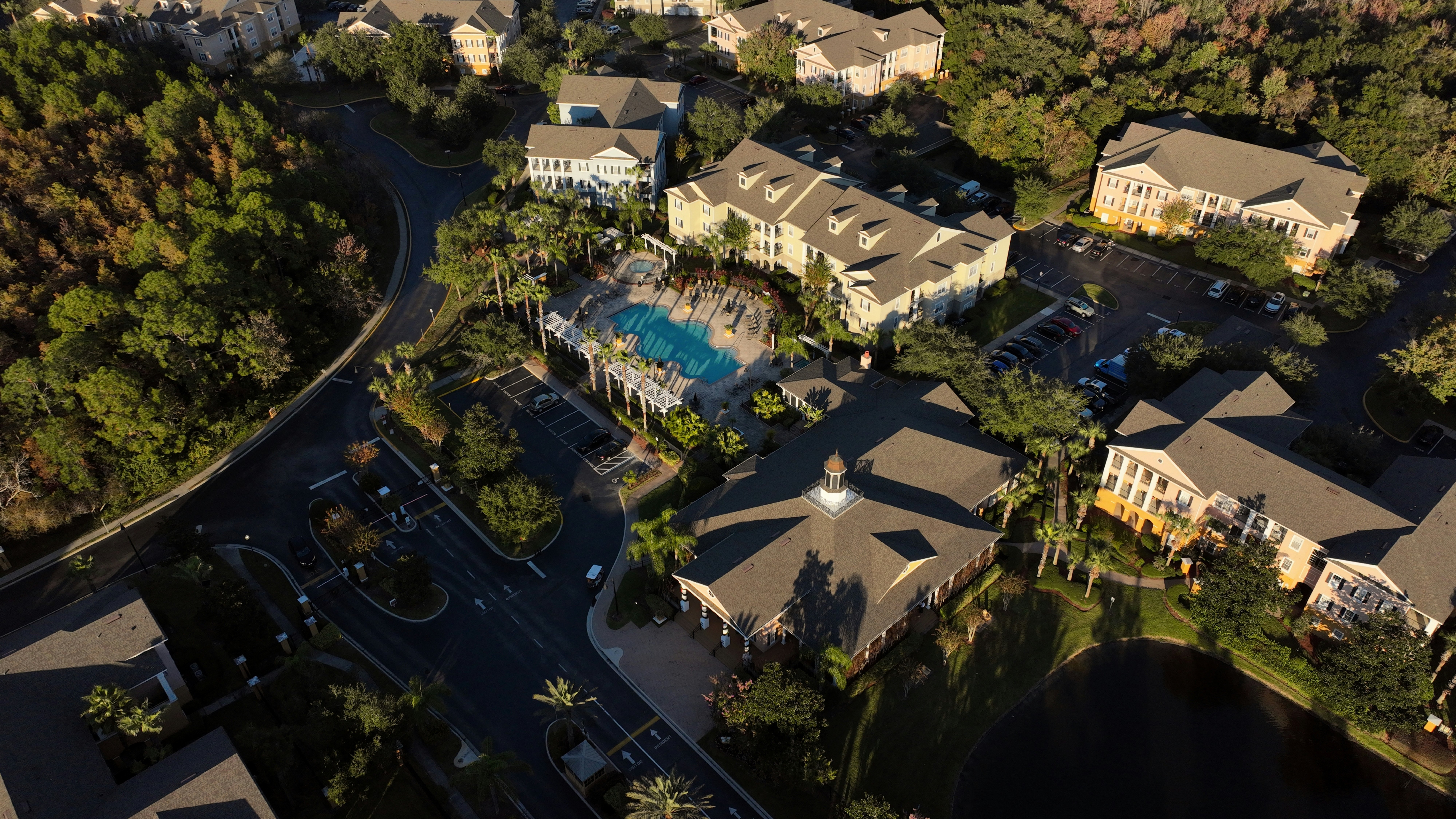 Aerial view of gated HOA community with pool — SW Florida