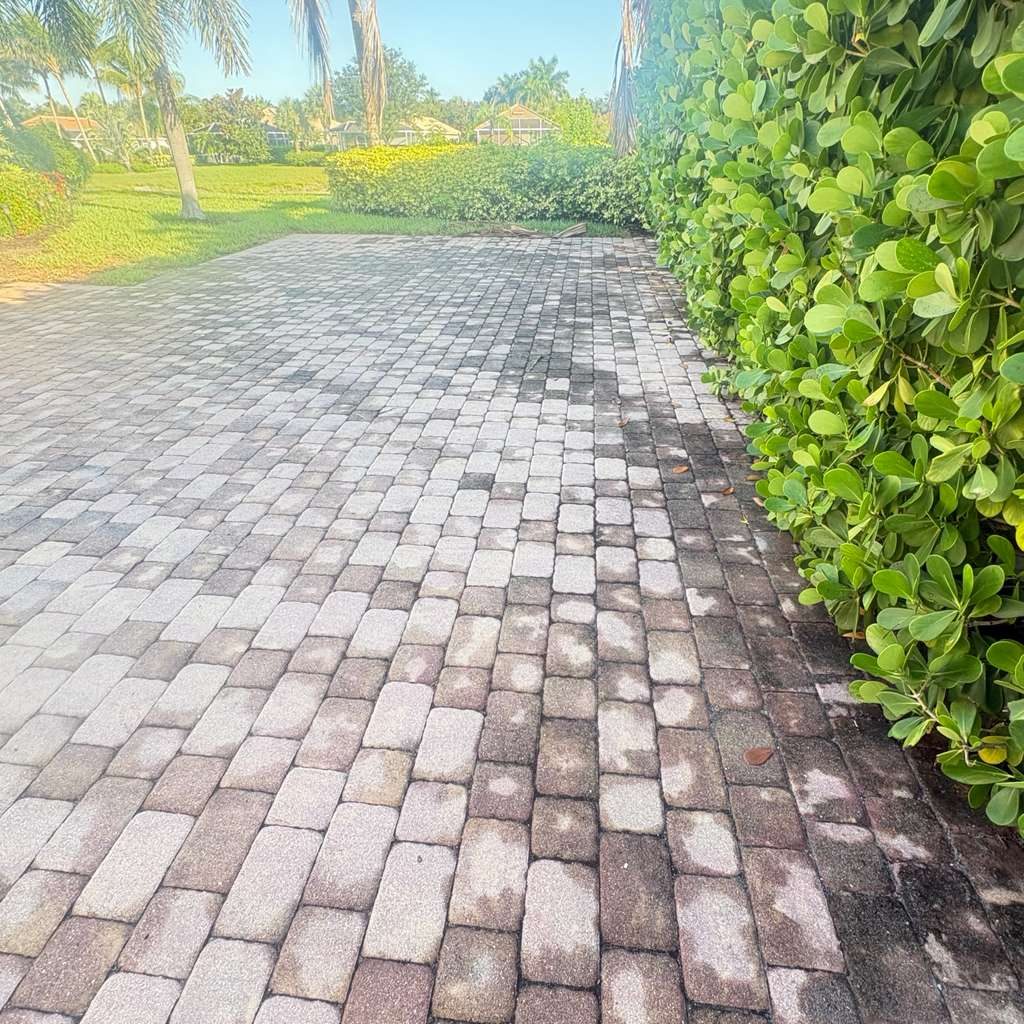 Stained paver driveway before pressure washing — Naples FL