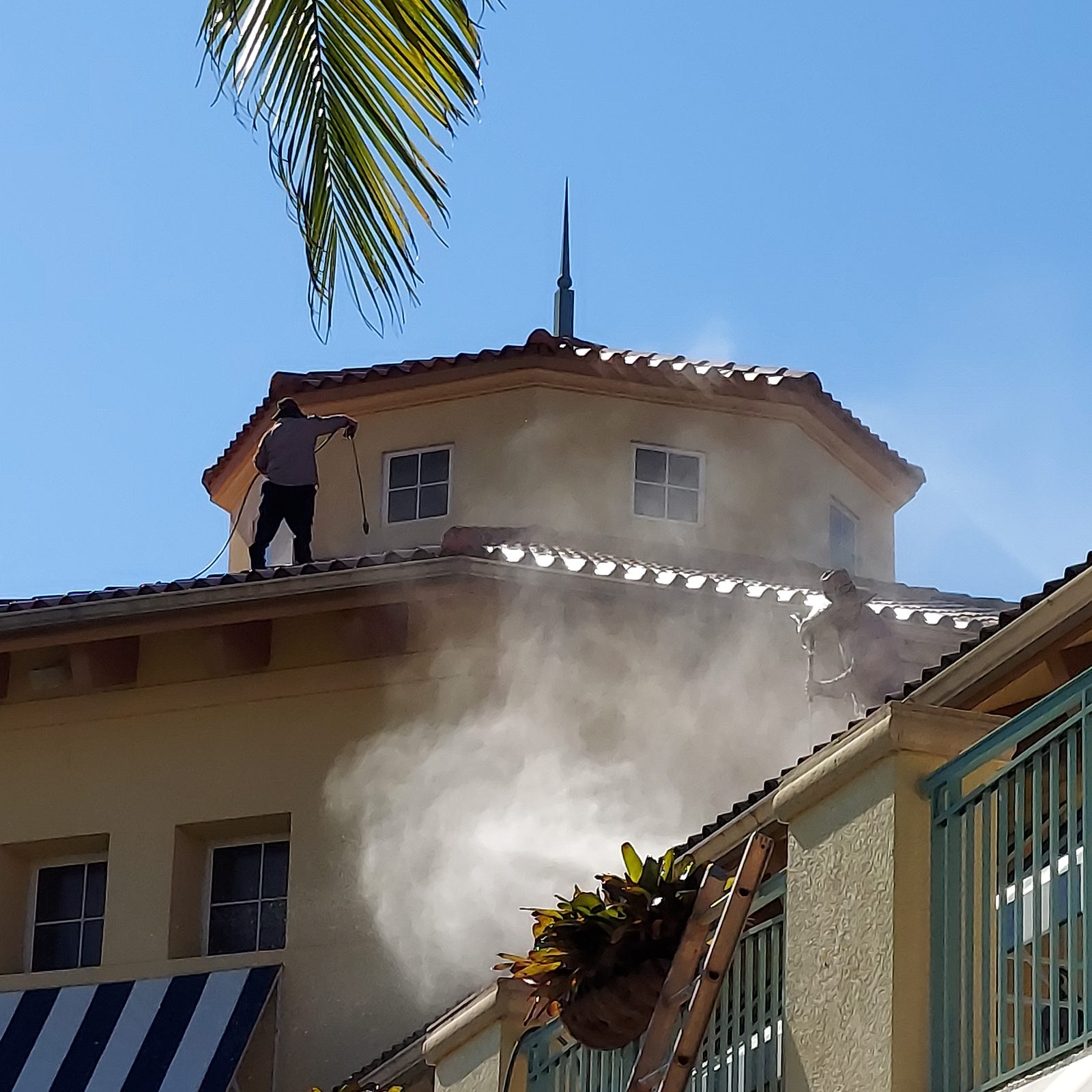 Roof cleaning with dramatic steam on commercial building — SW Florida