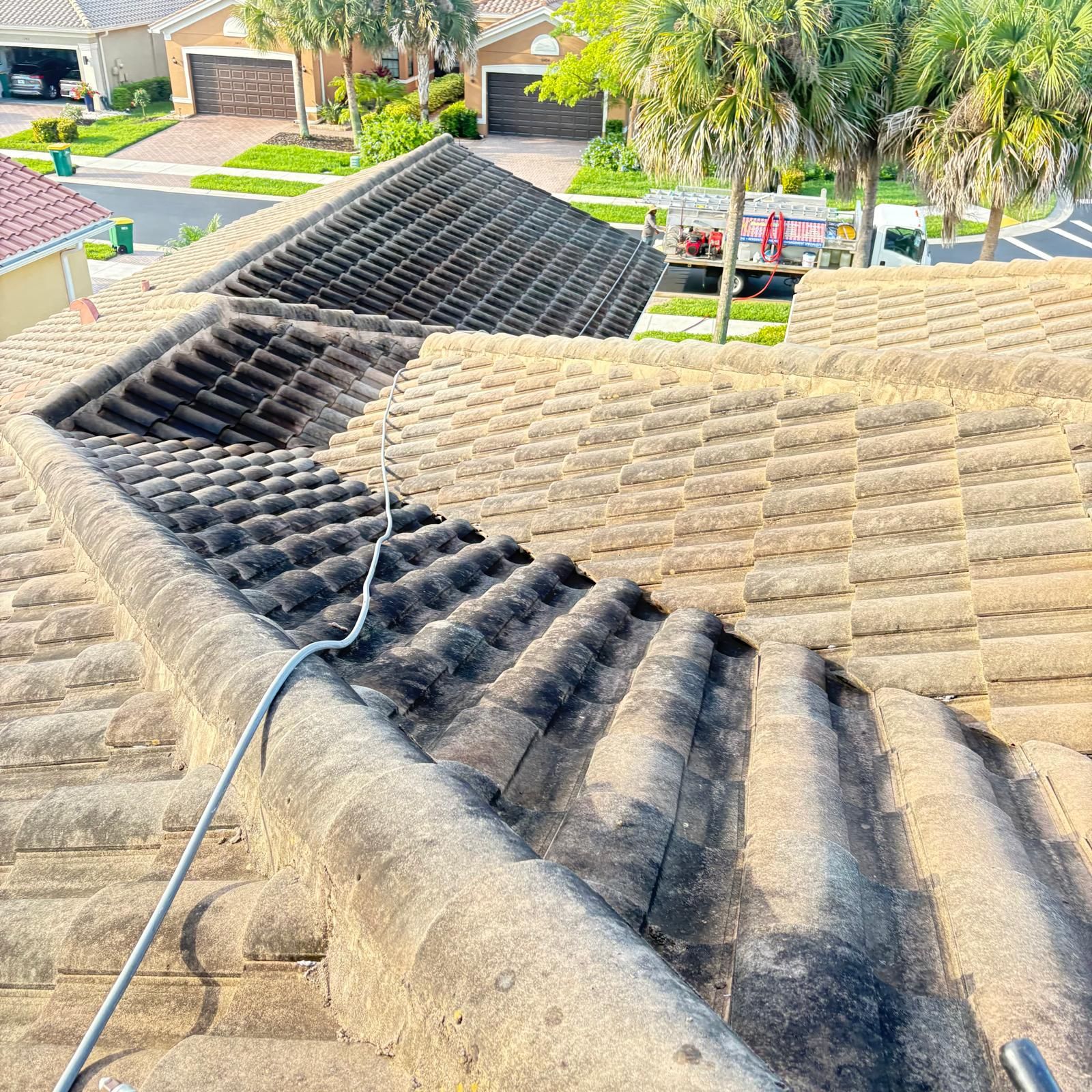 Heavily stained barrel tile roof before cleaning — HOA community SW Florida