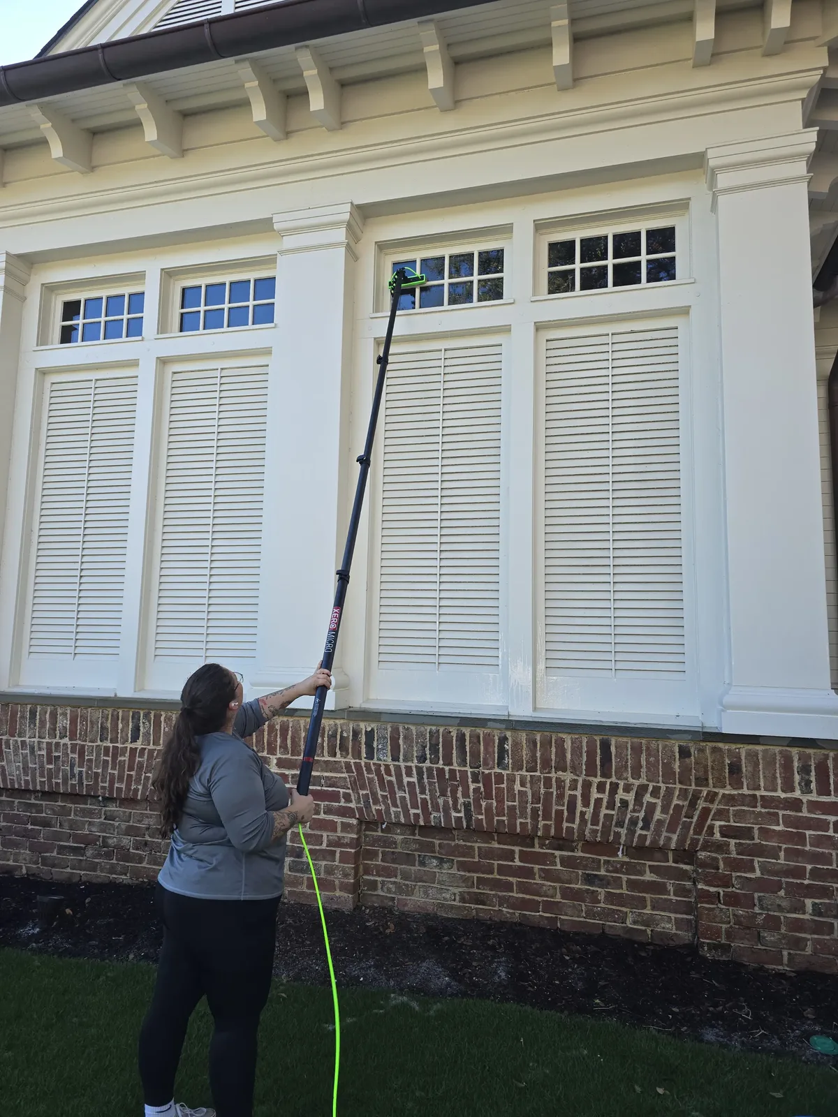 Window washing with water-fed pole at residential estate — SW Florida